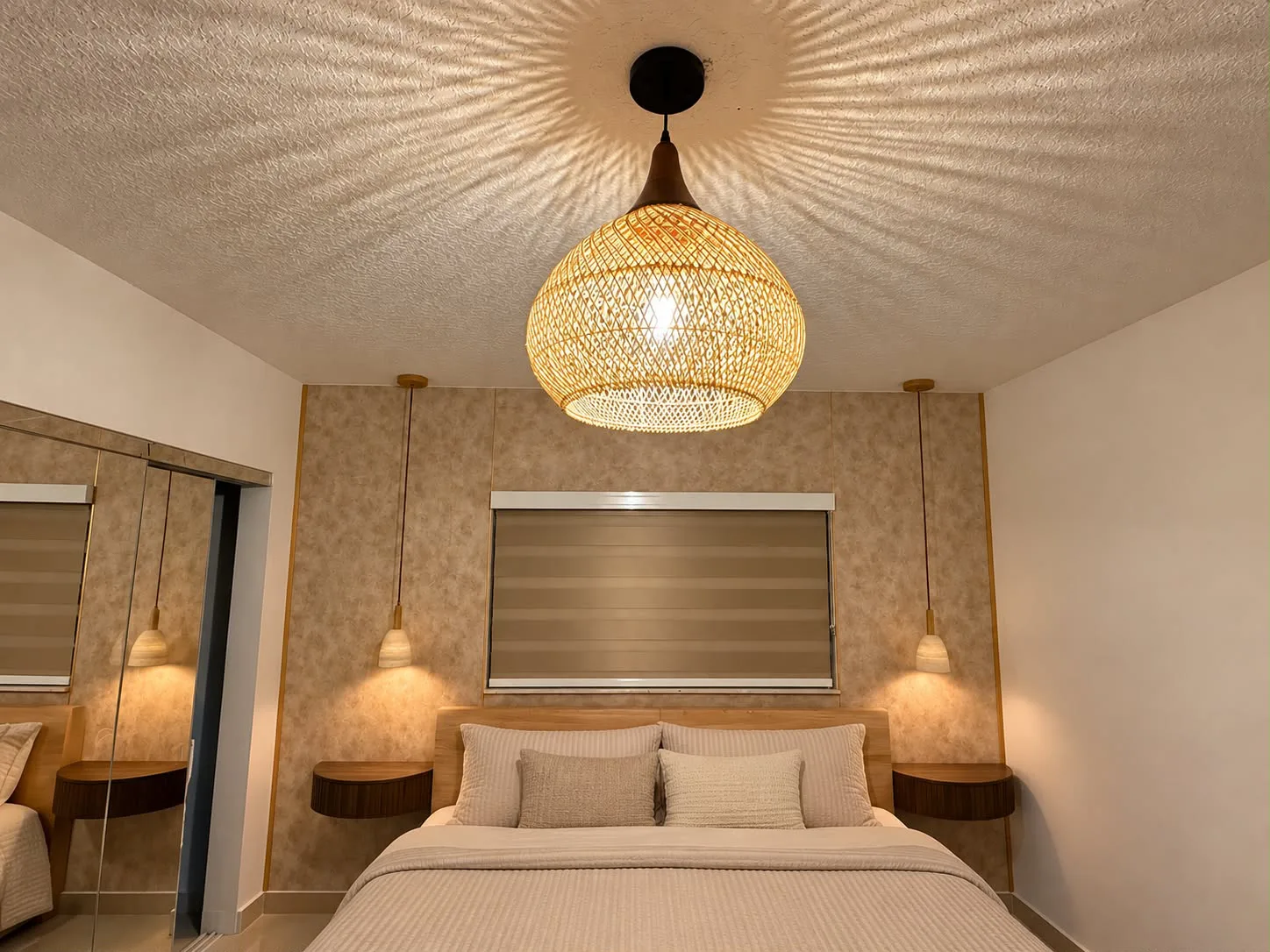 Woven rattan pendant and bedside lights installed above a bed in a Miami-Dade bedroom