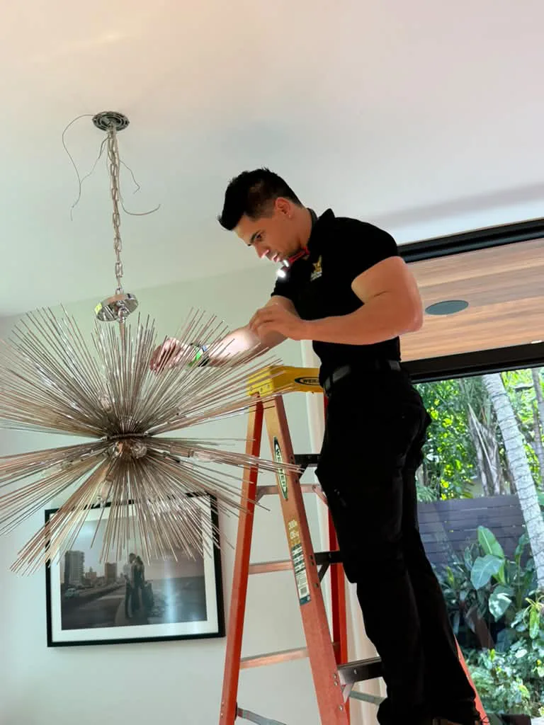 All Star electrician installing a sputnik chandelier in a Miami-Dade home