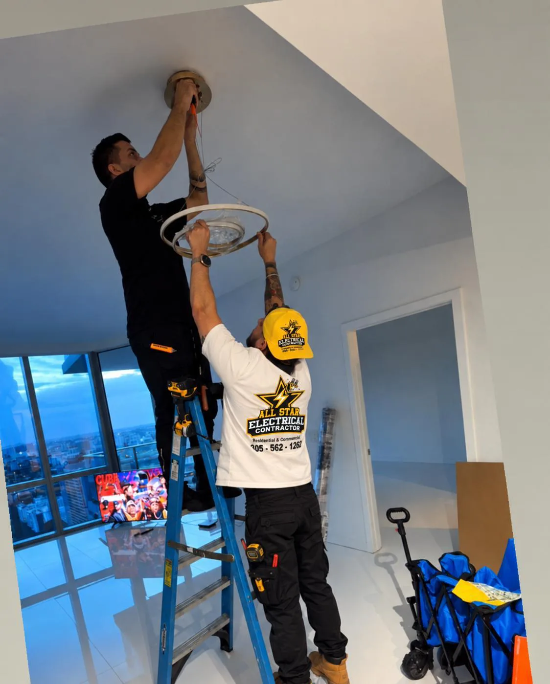 All Star Electrical Contractor crew installing a circular ceiling light in a high-rise residence