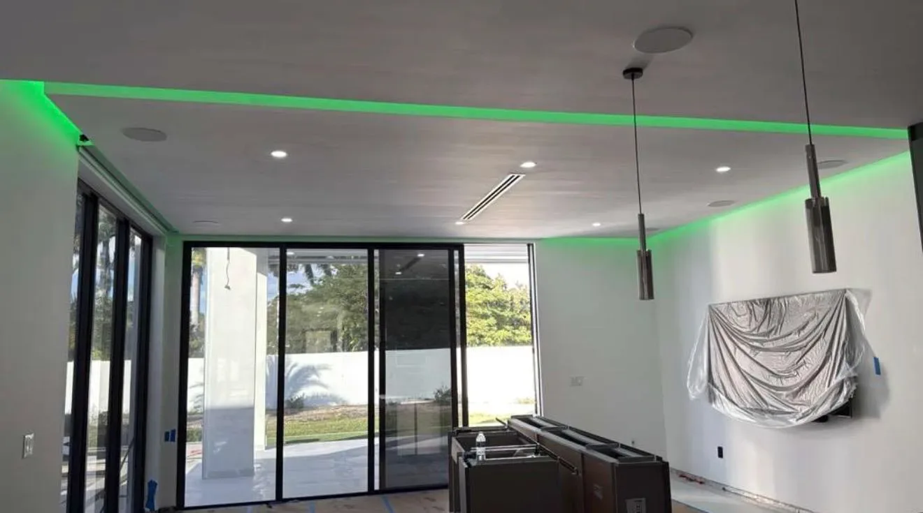 Green cove lighting and linear pendant lights in a Miami-Dade living room